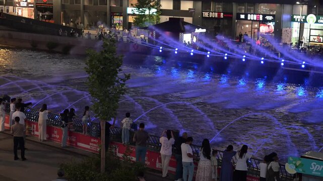 Tashkent, Uzbekistan - June 08, 2026: Seoul Mun Street.  Colorful fountain show with spectators enjoying evening performance.