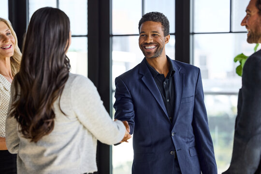 Shaking hands in a Modern Office