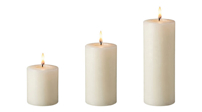 Three white pillar candles in varying heights, isolated. on transparent background