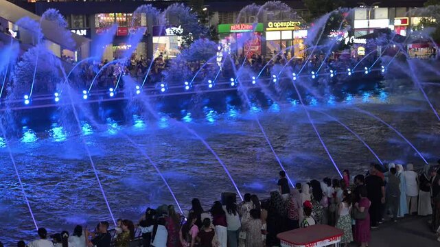 Tashkent, Uzbekistan - June 08, 2026: Seoul Mun Street.  Colorful fountain show with spectators enjoying evening performance.