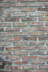 Fototapeta premium Multicolored vintage brick wall texture with weathered masonry. Architectural background for construction, renovation, design and real estate projects.