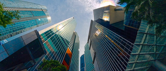 Low-angle view of modern glass skyscrapers with sunlight reflections © Towfiqu Barbhuiya 