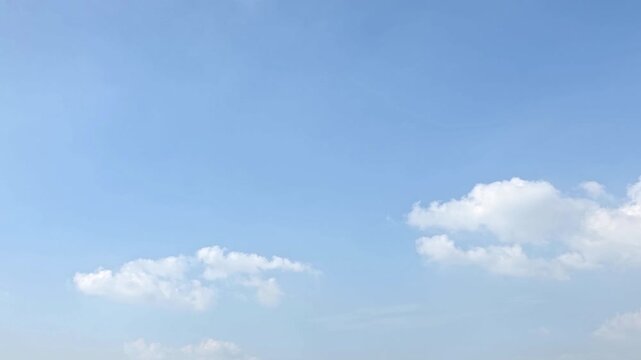 Cloudscape, Timelapse of Bright Blue Sky with Soft White Clouds and Copy Space for Background and Banner Design