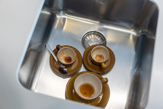 kitchen sink with dirty coffee cups