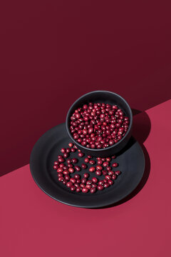 Bowl and plate with beans on a red background