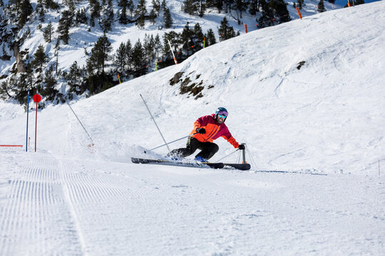 Skier enjoying a snowy descent in mountain landscape