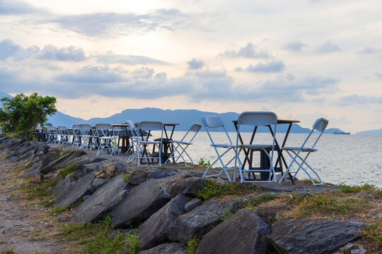 Seaside outdoor cafe seating at sunset in Banda Aceh