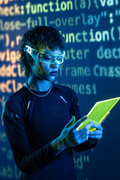 Cyberpunk woman in VR glasses reading neon tablet code