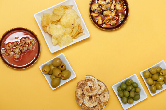 Spanish tapas aperitif with olives, chips, and seafood