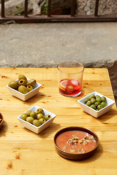 Spanish vermouth aperitif with tapas olives on table