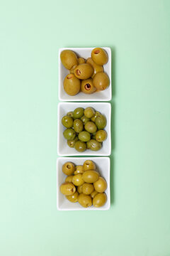 Spanish tapas green olives in bowls on pastel background
