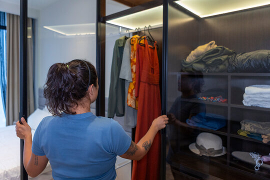 Woman choosing outfit from wardrobe for daily routine
