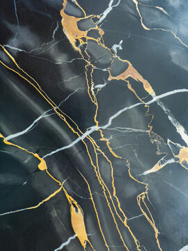 Dark marble background with gold and white veining