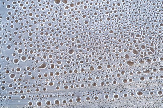 Raindrop pattern on clear glass surface
