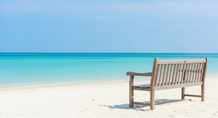 Fototapeta premium A tranquil wooden bench awaits relaxation on a pristine white sandy beach, offering a perfect scenic view of the calm turquoise ocean water, destination, tranquil, summer