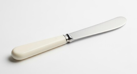 Fototapeta premium Classic Butter Knife with Ivory Handle on White Background