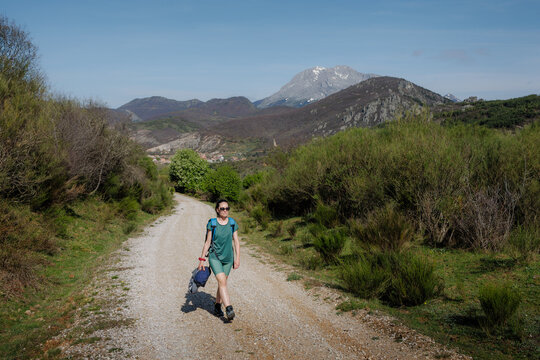 Woman hiking a mountain trail in northern Spain landscape