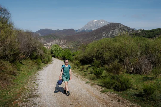 Woman hiking a mountain trail in northern Spain landscape