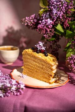 Homemade honey cake with lilac flower decoration