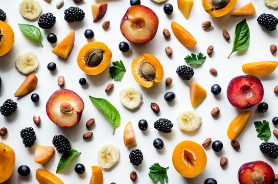 Vibrant fruit and nut arrangement on white background