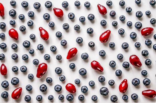 Blueberries and dogwood berries on white background