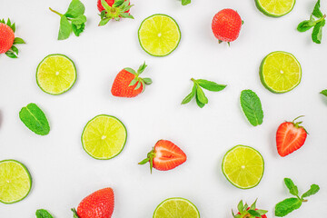 Obraz premium Strawberries lime slices and mint pattern on white background
