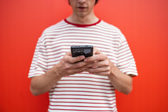 Curly haired man using smartphone in casual lifestyle