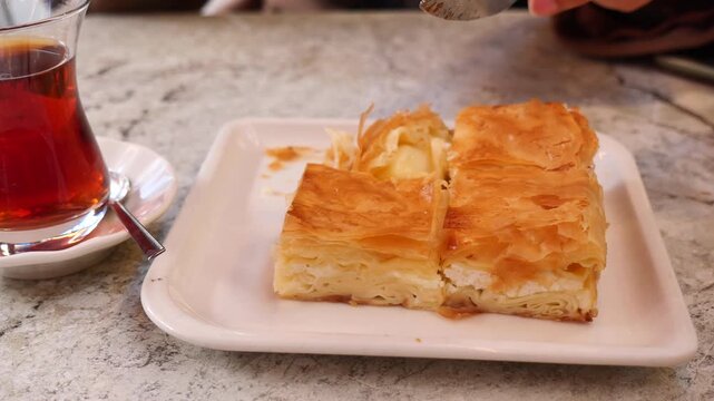 Enjoying turkish borek in a cafe during afternoon tea time