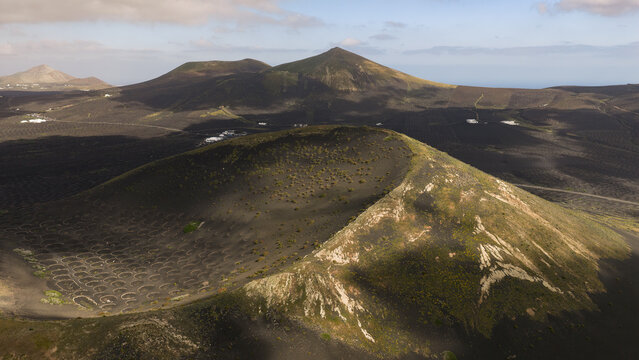Magical light over Lanzarote volcanic vineyard landscape