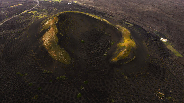 Aerial view of Lanzarote volcano and vineyard in magical light