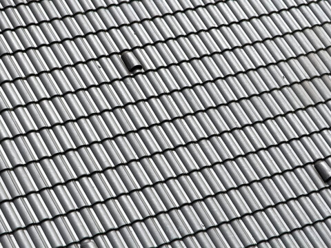 Gray roof tile pattern on residential construction rooftop
