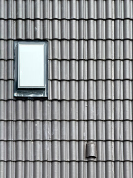 Grey roof tile pattern with skylight window in construction