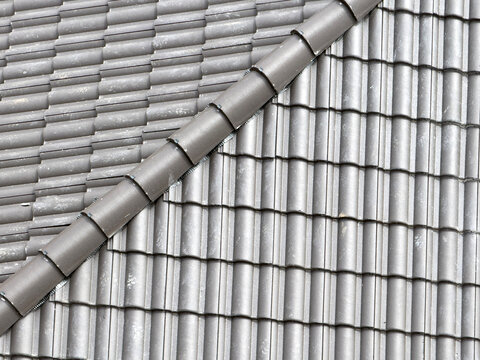 Close-up of gray roof tile ridge on modern roof slope