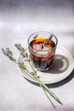 Refreshing ice coffee with lavender on sunny day