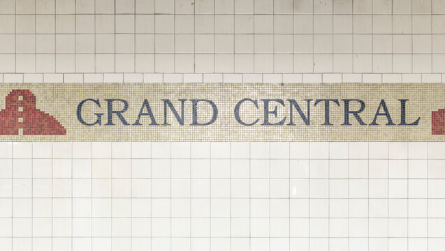 grand central sign on white pole in new york city subway station at 42nd street in midtown (4,5,6,7 and shuttle train) commuter stop travel tourism manhattan nyc usa america