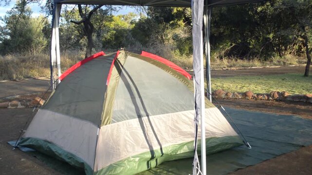 Camping tent erected halfway with gazebo
