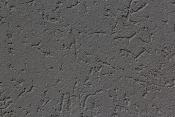Fototapeta premium Neutral gray stucco wall texture close-up showing rough plaster surface and architectural detail