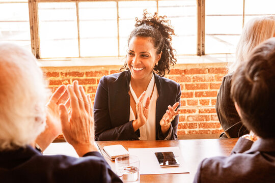 Business meeting with diverse professionals clapping