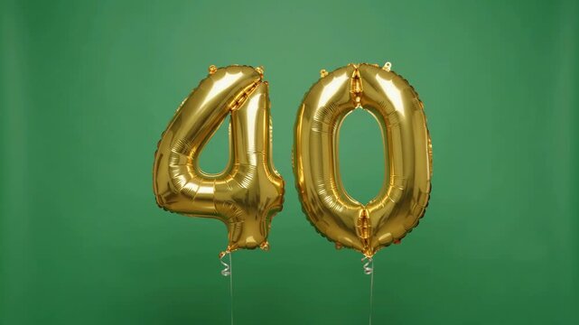 Golden inflatable balloons in the shape of number 40 floating and slightly rotating against a green screen. This festive element is perfect for a 40th birthday celebration