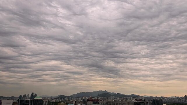 Cloudscape, Timelapse of Rippled Asperitas Storm Clouds over Seoul City Skyline with Mountains for Weather Background