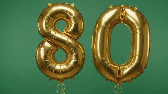 Golden foil balloons in the shape of number 80 swaying against a green chromakey background. Perfect footage for creating festive videos for an 80th anniversary or birthday.