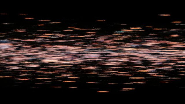 Abstract orange light streaks on black background.