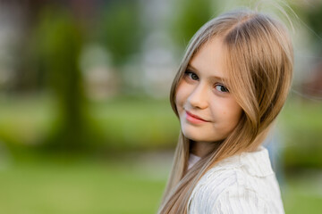 Naklejka premium portrait of a cute schoolgirl with long blond hair