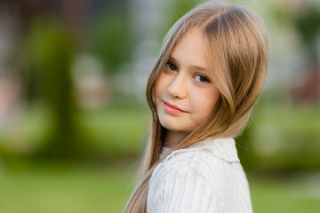 Fototapeta premium portrait of a cute schoolgirl with long blond hair
