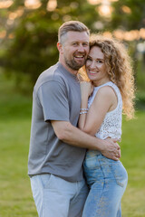 Fototapeta premium couple of man and woman hugging in the summer in a city park