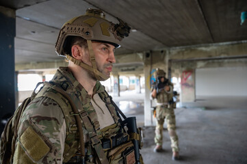 Fototapeta premium Special armed military squad team in full gear patrolling an abandoned building during hostage mission