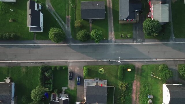 Aerial top down drone shot of a rural residential neighbourhood in Nova Scotia, Canada. Cinematic overhead footage featuring suburban homes, roads, and countryside landscape.