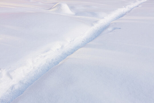 path in the snow, a trampled footpath in a deep snowdrift after a snowfall