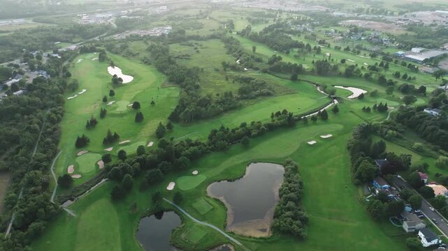 Wide drone shot of a golf course in Truro, Nova Scotia moving right in a smooth circular motion, expansive aerial view of rolling fairways and greens, cinematic landscape, peaceful outdoor