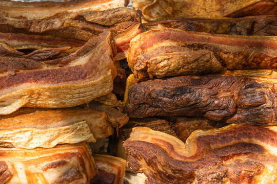 Close up of golden brown fried pork belly chicharron slices
